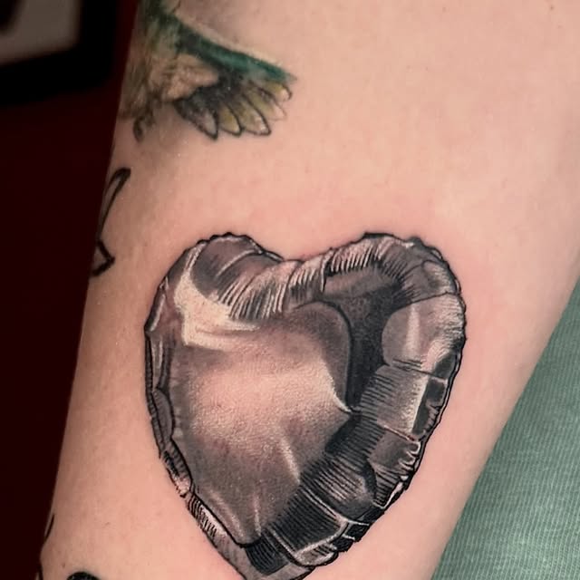 Chrome broken-heart tattoo by Marcus Arroyo